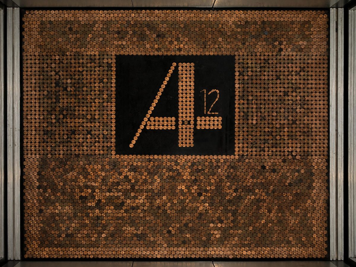 Elevator cab with custom penny tile floor