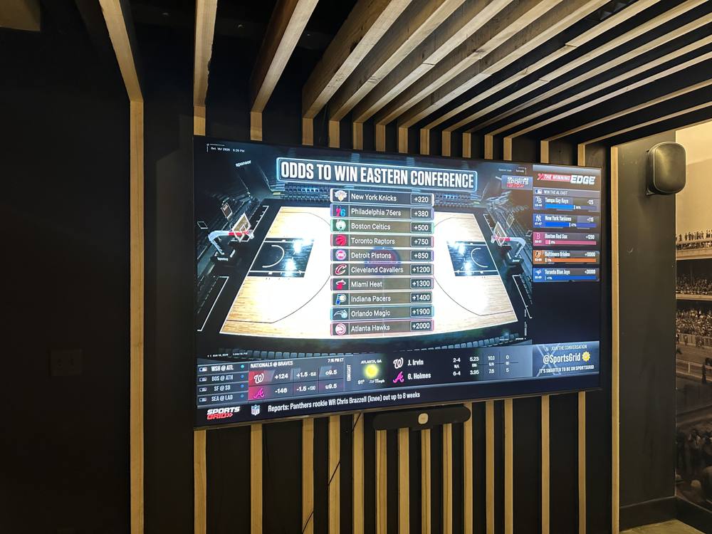 100 inch TV showing live sports