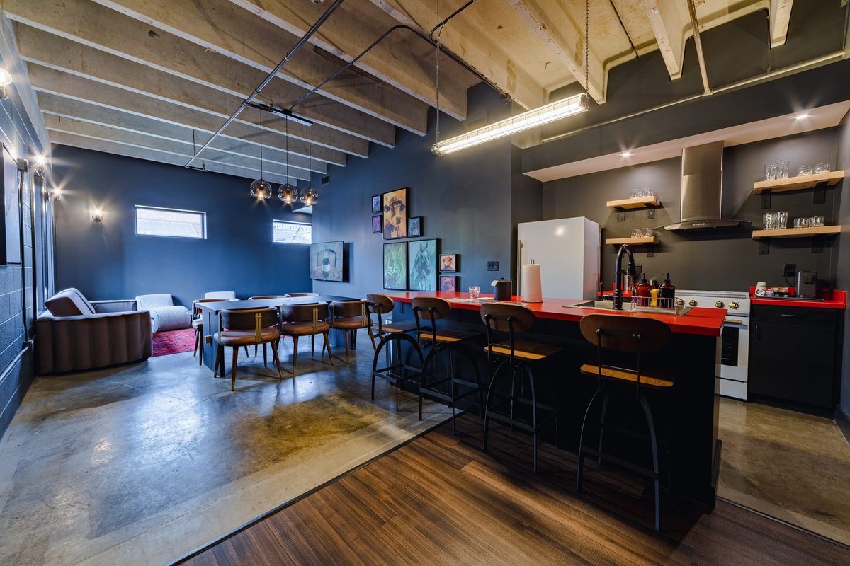 Stakes suite kitchen with red counters and open living area